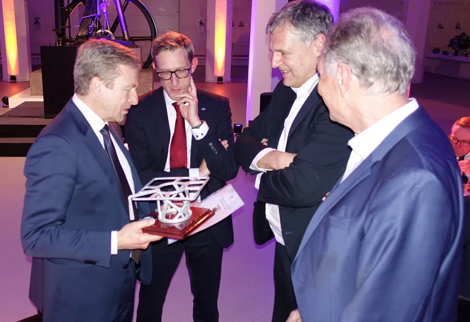 From left: Oliver Zipse, Rüdiger Daub, Wolfram Volk, and Klaus Drechsler, Photo: private Oliver Zipse, Chairman of the Board of BMW AG with his unique, topology-optimised professorial hat and is surrounded by Rüdiger Daub (iwb), Wolfram Volk (utg) and Klaus Drechsler (LCC). All three are also institute directors of Fraunhofer IGCV