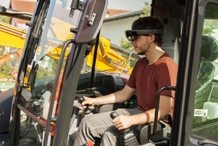 Driver sits with a Hololense on the excavator